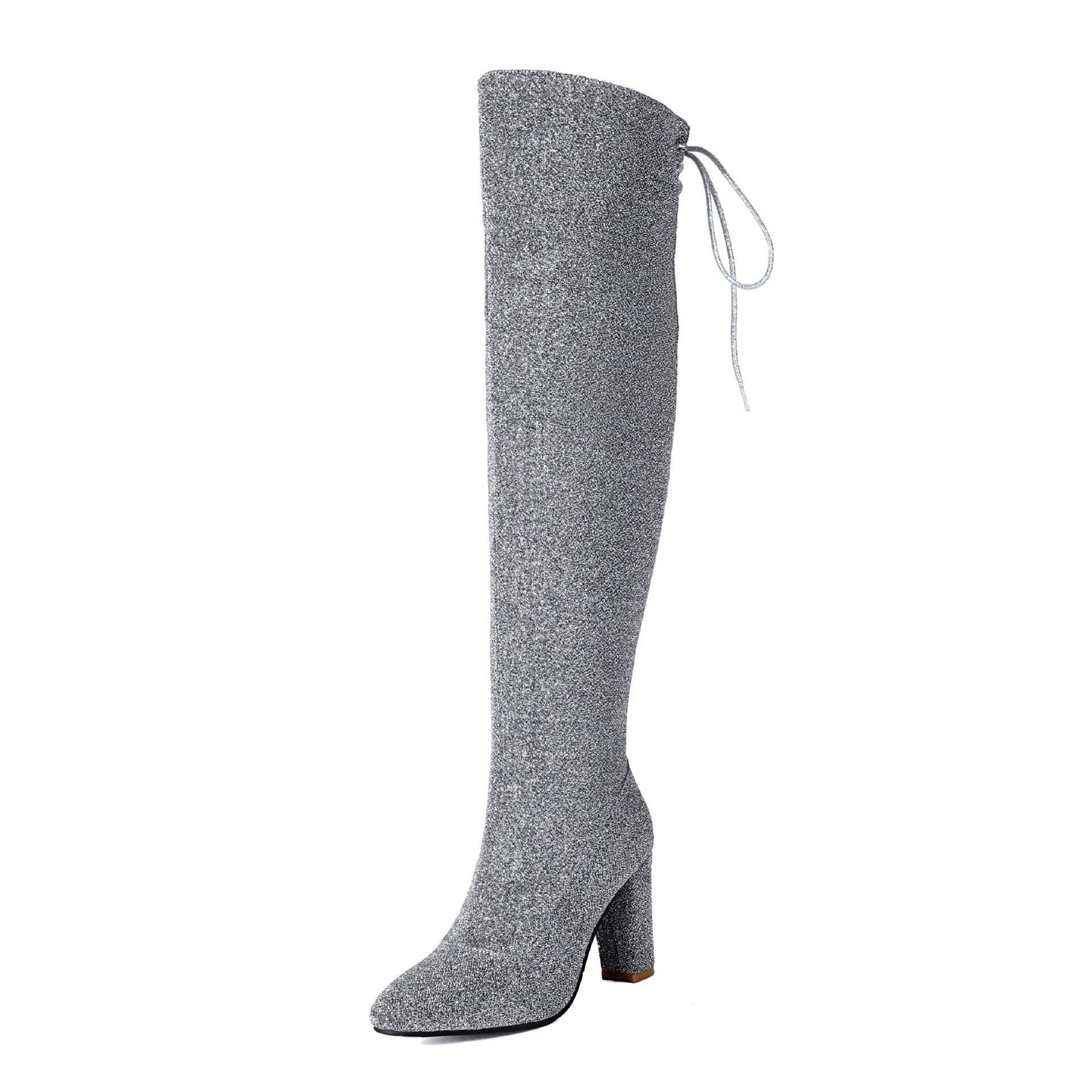Sparkly silver over-the-knee boots with block heel and side tie detail, perfect for trendy fashion looks.