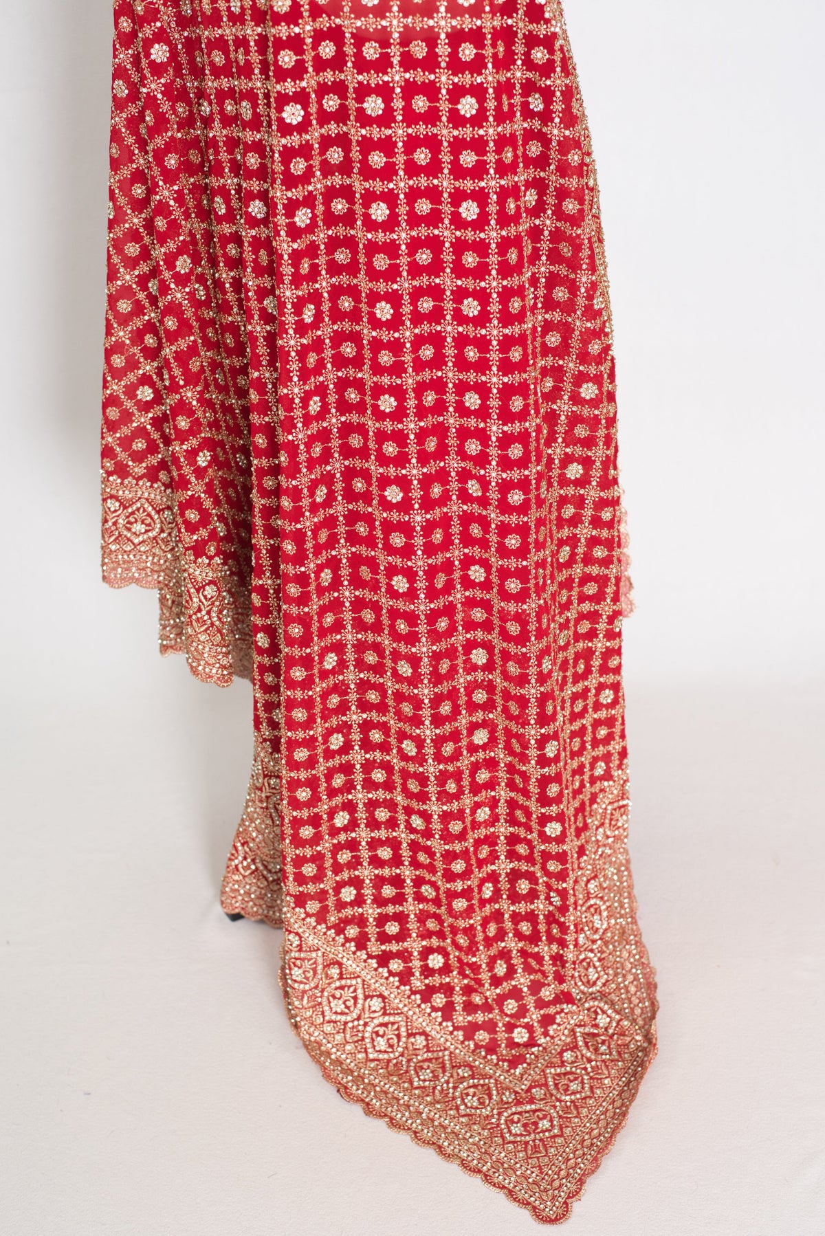 Eva Red & Gold Georgette Festive Saree — close-up of the hanging fabric and woven border