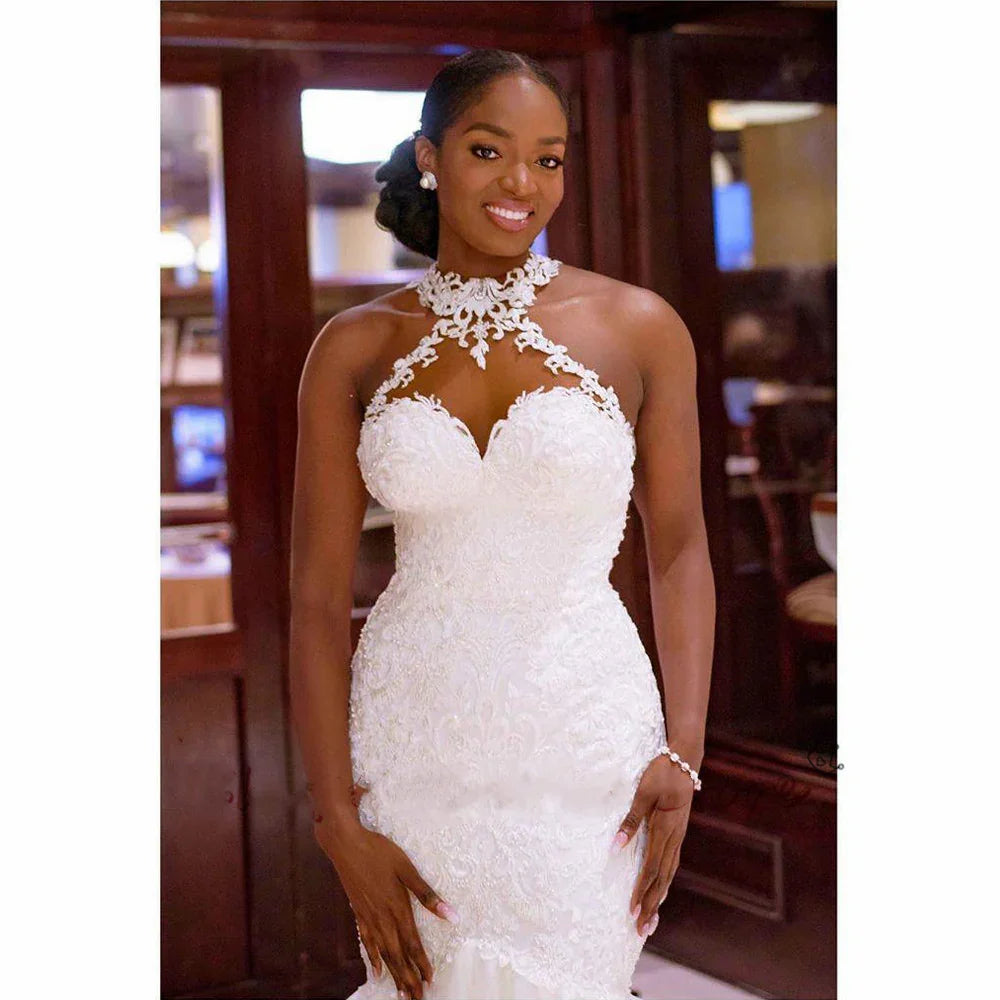 Elegant white lace mermaid wedding dress with halter neckline, perfect for bridal fashion