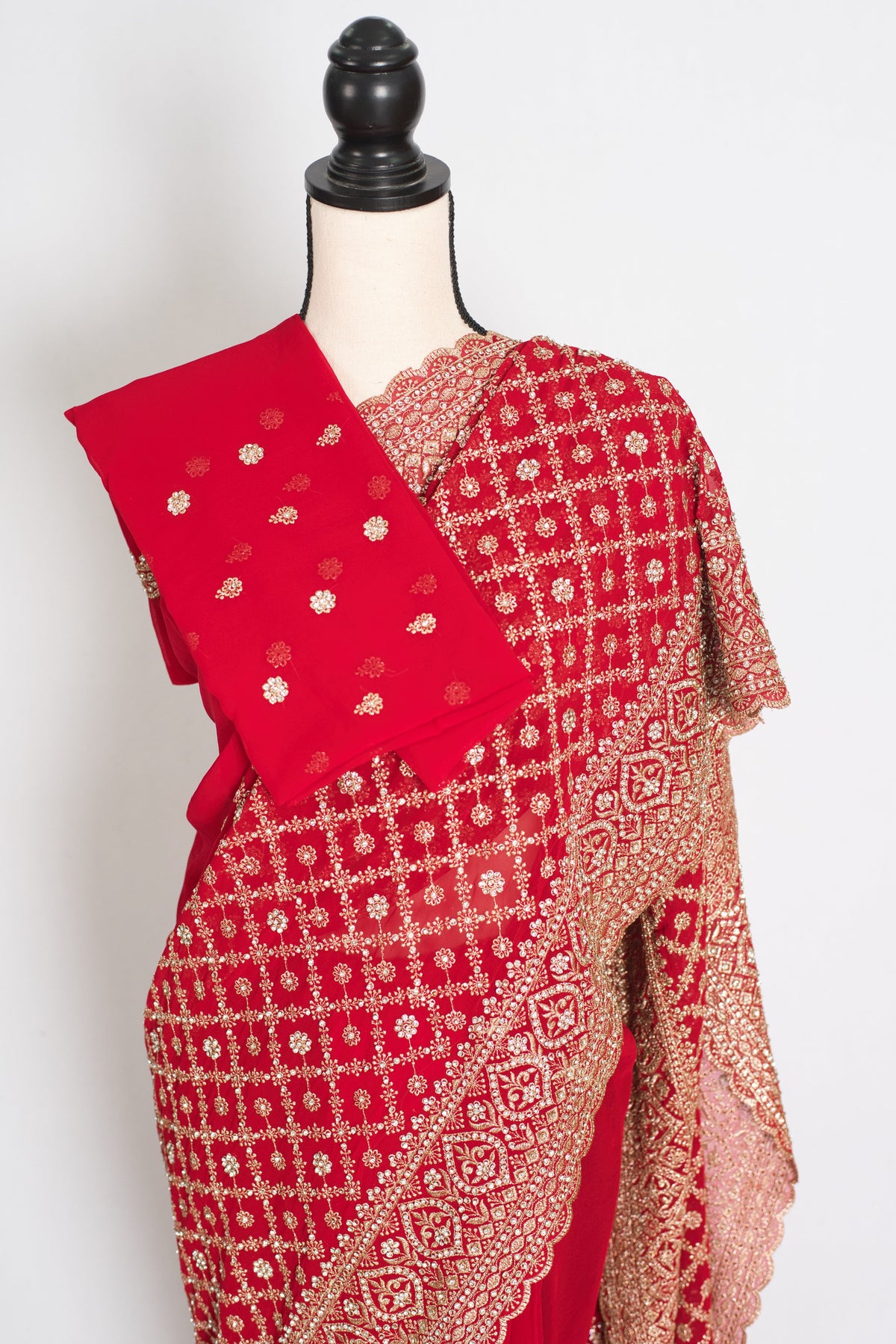 Eva Red & Gold Georgette Festive Saree — front view with the blouse piece draped over the shoulder