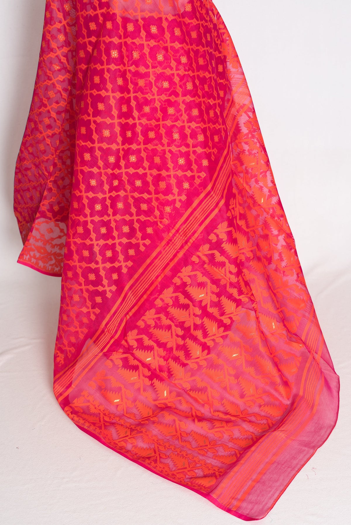 Nagma Pink & Orange Jamdani Saree — close-up of the hanging fabric and woven border
